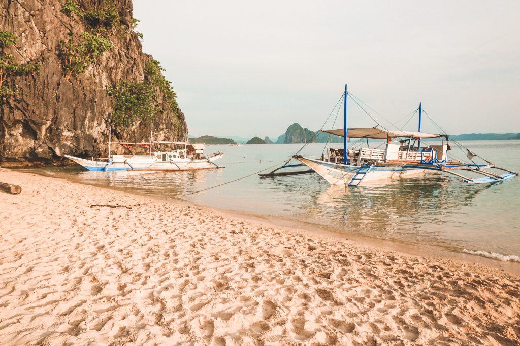 Boats in water on island in Philippines