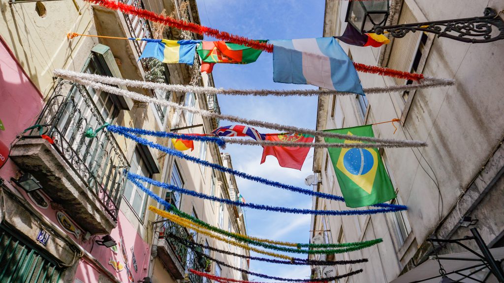 Flags hanging on buildings in Lisbon Portugal