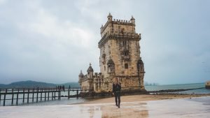 Woman walking in front of Tower of Belem