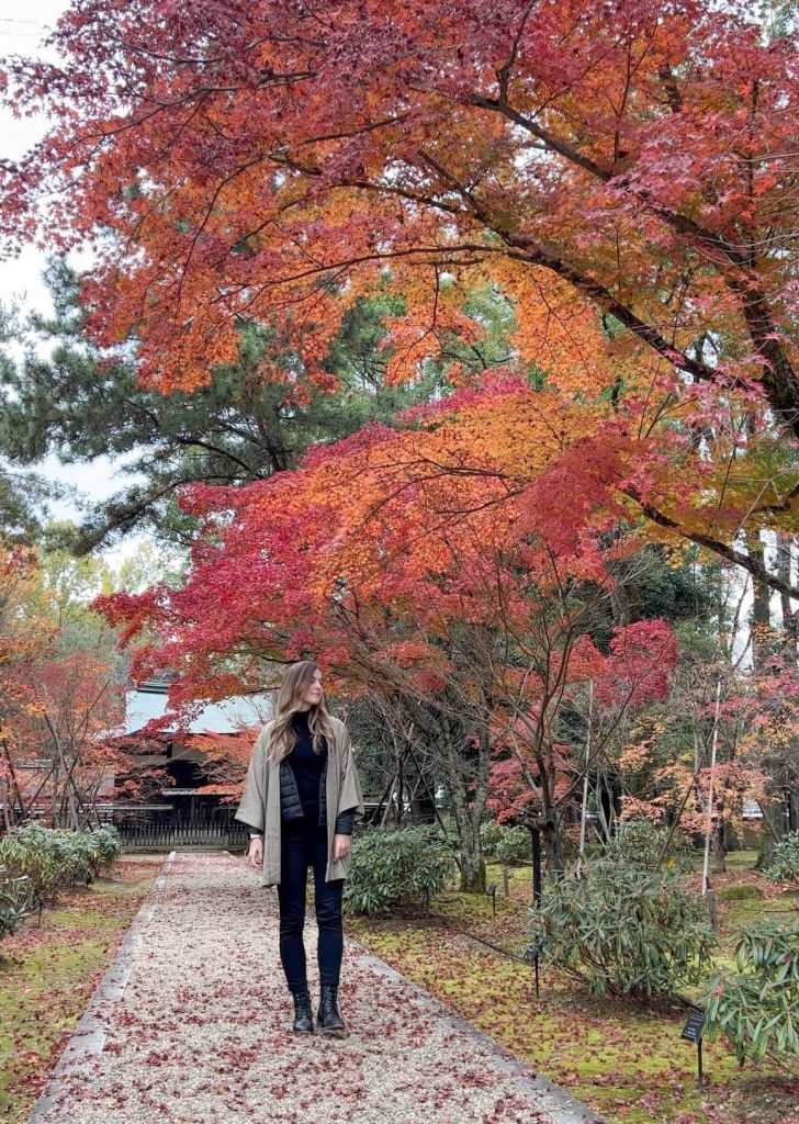 Woman under fall foliage trees at Ninna-ji temple